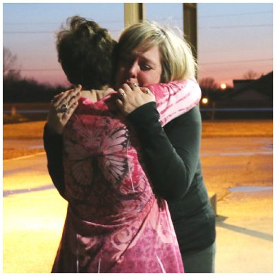Teresa Parker, left, hugging Devin Muller at Sweet Grace study in April, 2014.