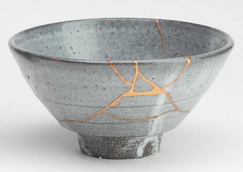 Kintsugi, the Japanese art of repairing broken pottery with adhesive resin mixed with gold dust.