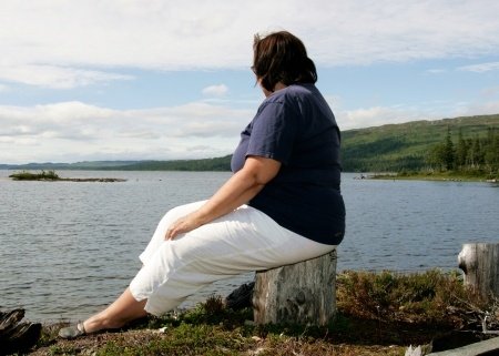 overweight woman by lake