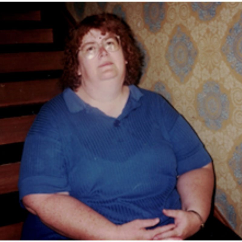 Super morbidly obese woman tired sitting on stairs
